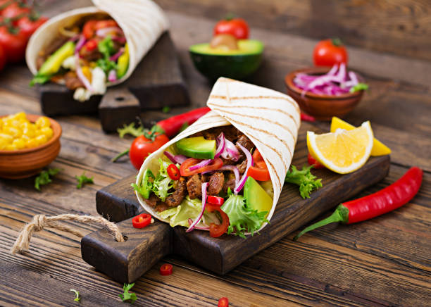 istock Mexican tacos with beef in tomato sauce and avocado salsa 906661076