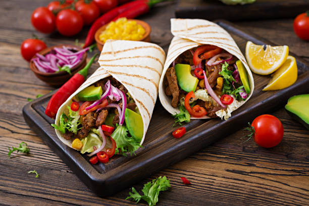 istock Mexican tacos with beef in tomato sauce and avocado salsa 906661190
