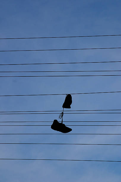 Shoes on a wire. stock photo
