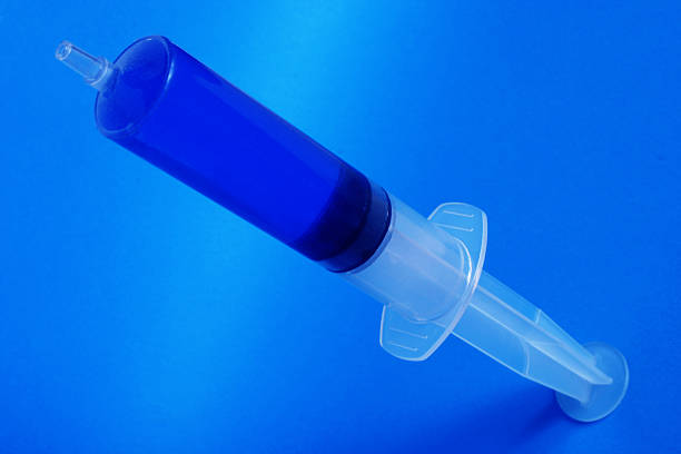 syringe with the blue stuff stock photo