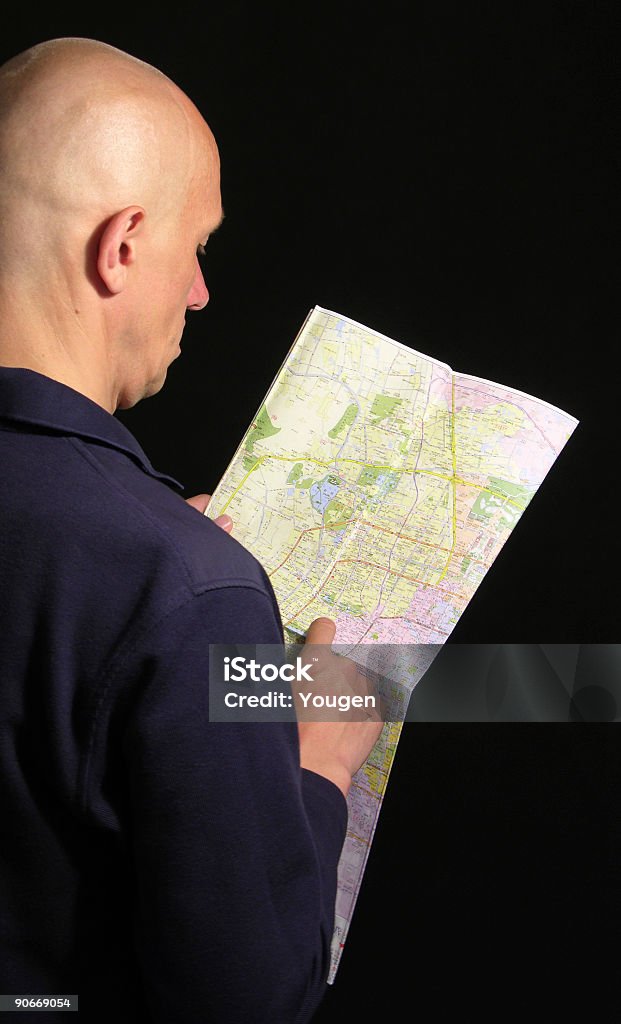 The man look into a map in the Chinese language.  Adult Stock Photo