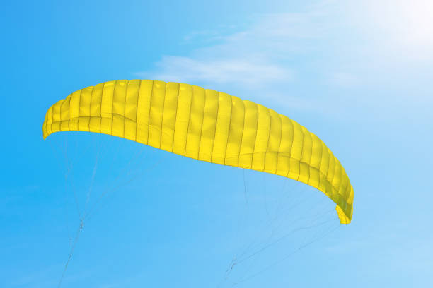 istock Flight yellow parachute in a blue sky. 906691812