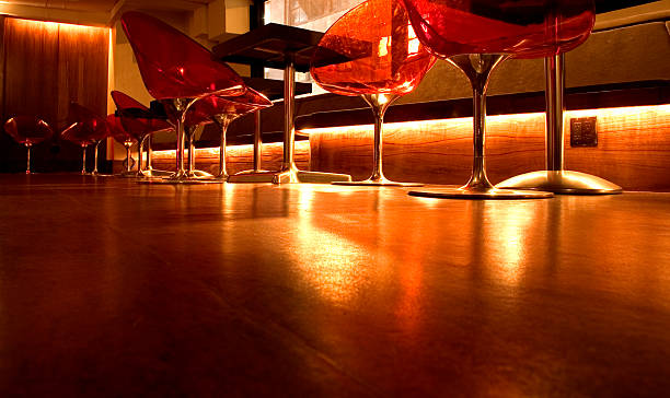 Bar counter with high chairs in empty cozy restaurant