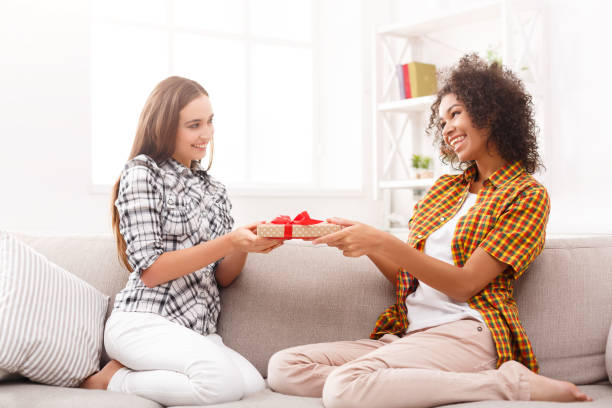 istock Excited woman getting gift from her friend 906715468