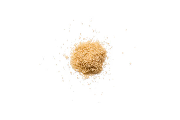 istock Heap of organic raw brown sugar isolated on white background 906715672
