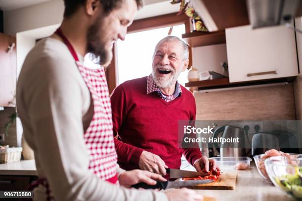 Hipster Son With His Senior Father Cooking In The Kitchen Stock Photo - Download Image Now