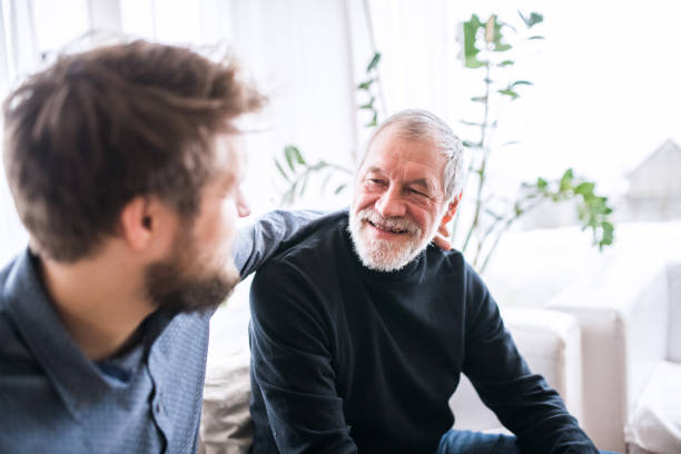 istock Hipster son with his senior father at home. 906716162