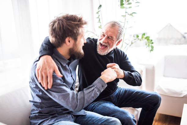 istock Hipster son with his senior father at home. 906716212