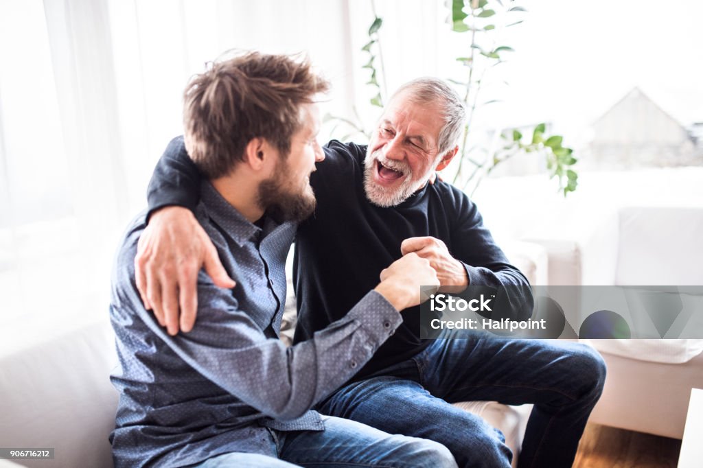 Hipster son with his senior father at home. Hipster son with his senior father at home. Two generations indoors, having fun. Father Stock Photo