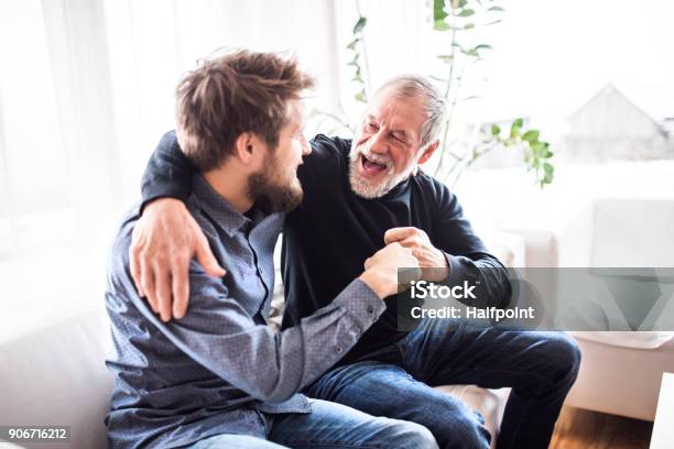 Hipster Son With His Senior Father At Home Stock Photo - Download Image Now - Father, Senior Adult, Young Adult