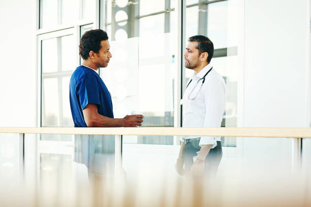 istock Medical personnel talking during break 906716470