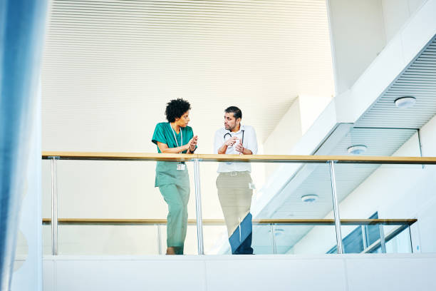 istock Doctor talking with nurse in hospital 906716612