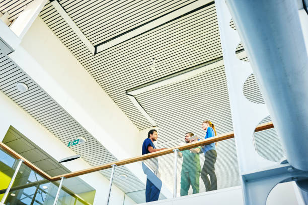 istock Medical staff discussing in hospital corridor 906717268