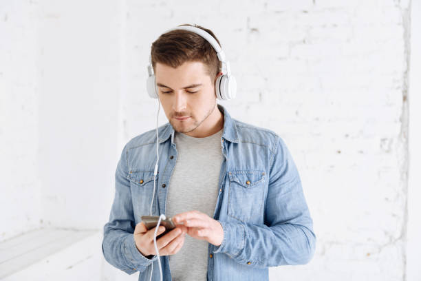 istock Attentive bearded man looking at his telephone 906719788