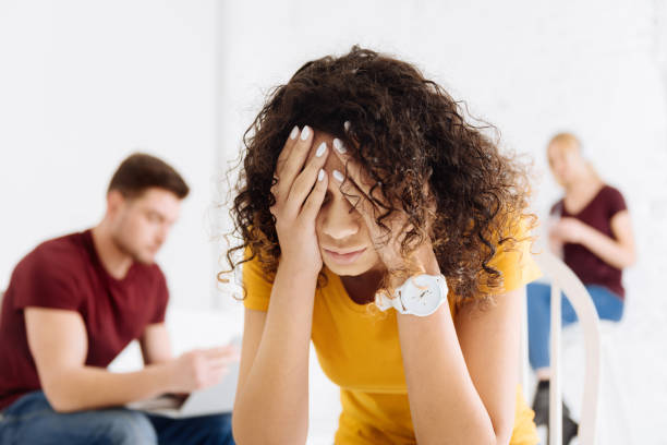 istock Tired young woman covering her face 906720166