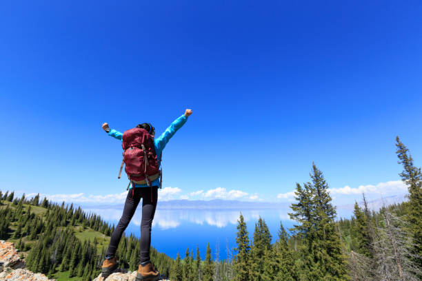 istock successful Hiker outstretched arms on mountain top 906723924