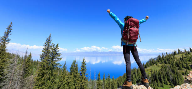 istock successful Hiker outstretched arms on mountain top 906724162
