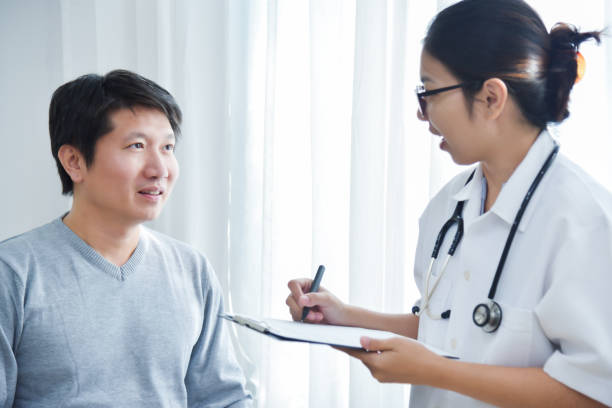 istock Female Doctor examining male patients. 906724334