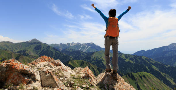 istock successful Hiker outstretched arms on mountain top 906727032