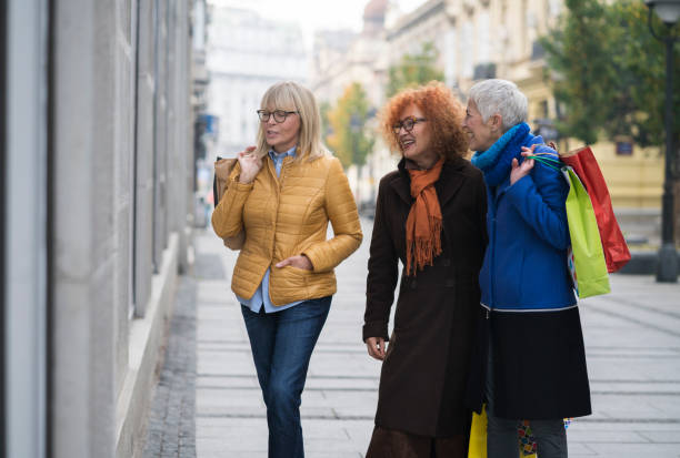 istock Three mature women out in shopping 906727172