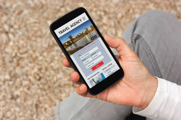istock Hand holding smart phone with travel agency concept on screen 906727320