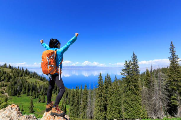 istock successful Hiker outstretched arms on mountain top 906727356