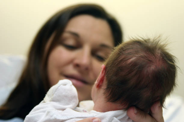 young hispanic latina mother and baby in her arms while walking outdoors