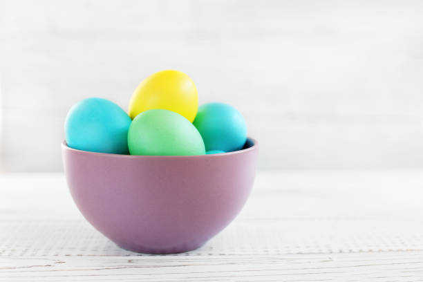 istock Colored eggs in a bowl. The concept of Easter and spring. 906731174