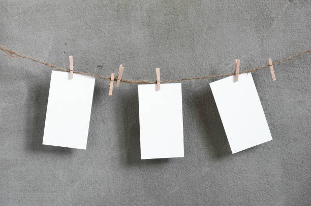 istock Three small sheets of white paper handing on the rope 906731340