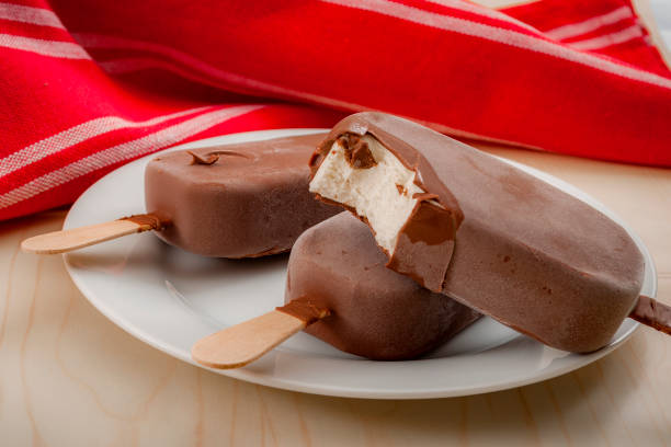 Bars of vanilla ice cream on a stick with chocolate