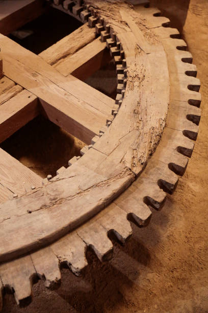 istock ancient wooden gearwheel 906734776