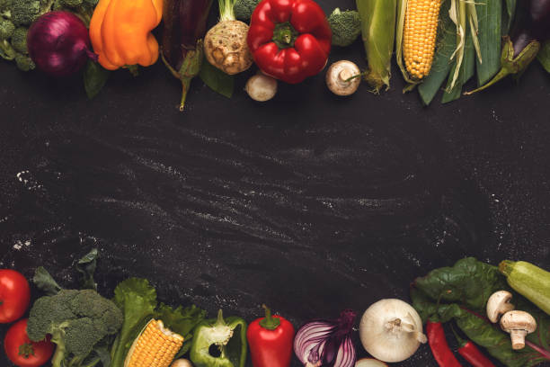 istock Border of fresh vegetables on wooden background with copy space 906735244