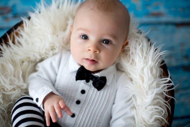 istock Little baby boy with knitted ladybug hat and pants in a basket 906739972