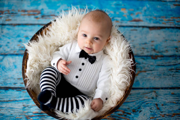 istock Little baby boy with knitted ladybug hat and pants in a basket 906741084