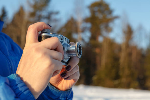 istock Old camera in hands, photography concept 906752348