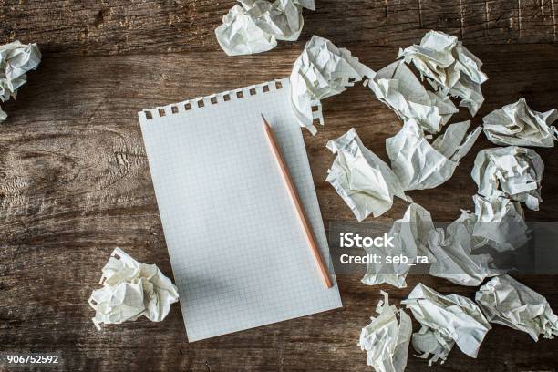 White Square Paper Pencil And Wasted Papers On Wooden Back Ground Stock Photo - Download Image Now