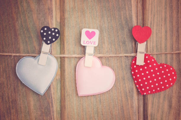 istock Valentines day hearts hanging on wooden background. 906757160