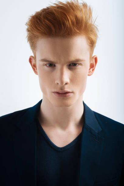 istock Suspicious red-headed young man staring 906758694