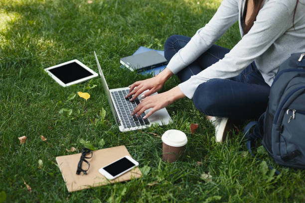 istock Young pensive woman using laptop in park 906759734