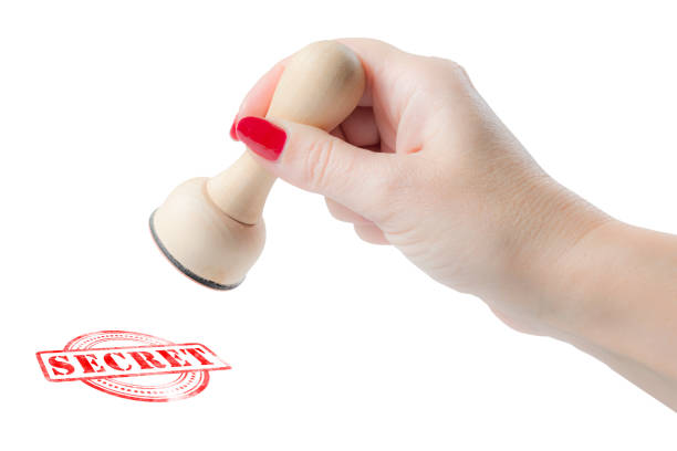istock Hand holding a rubber stamp with the word secret 906762584