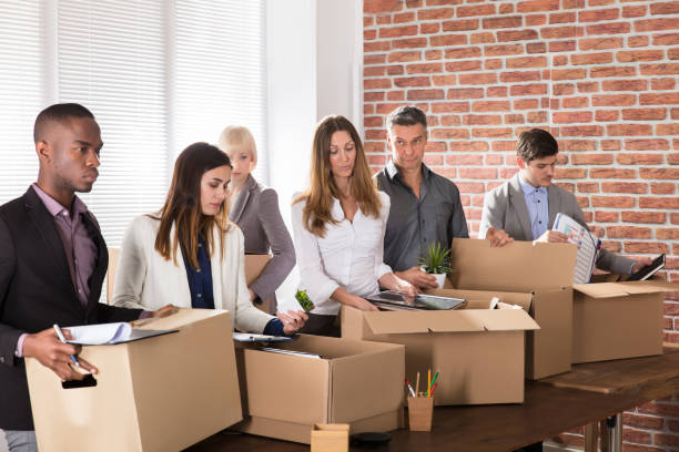 istock Businesspeople Packing Belongings In Cardboard Box 906762634