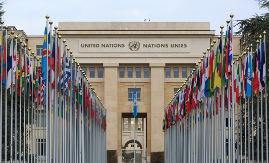 GENEVA, SWITZERLAND - December 17, 2017: Allee des Nations (Avenue of Nations) of the United Nations Palace in Geneva, with flags of the member countries.