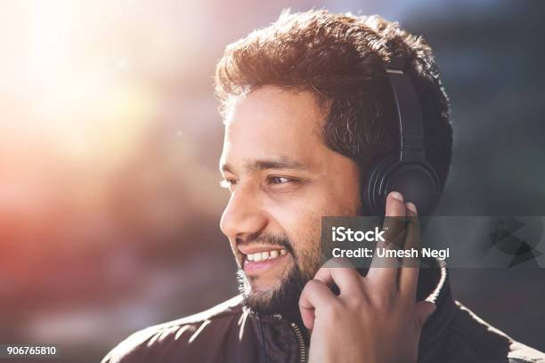 Young Asian Indian Man Listening To Music Stock Photo - Download Image Now - 30-34 Years, Adult, Adults Only