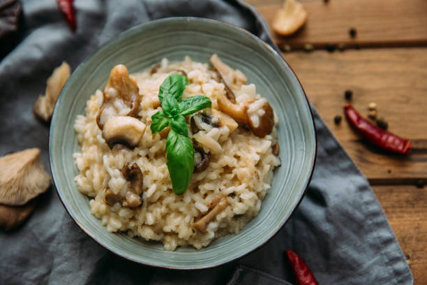istock Risotto with mushrooms on an old wooden background. Rustic style. 906766150