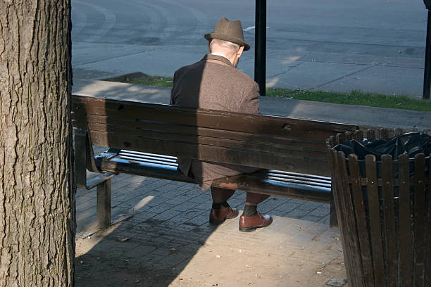 istock Man sitting alone on a city bench 90676634