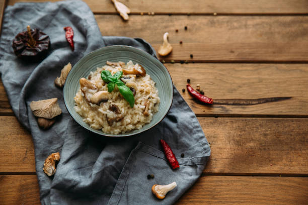 istock Risotto with mushrooms on an old wooden background. Rustic style. 906769348