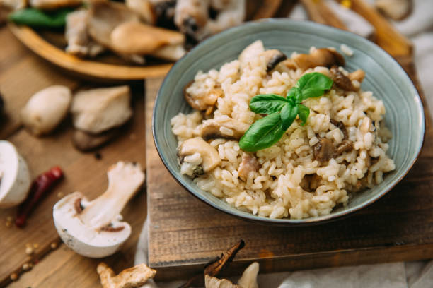 istock Risotto with mushrooms on an old wooden background. Rustic style. 906769350