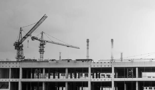 istock Construction site, crane towers, concrete tanks and buildings 906769502