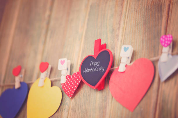istock Lovely hearts hanging on wooden background. Write your message. 906769538