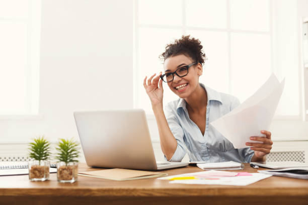 istock Happy business woman reading document at office desktop 906769600
